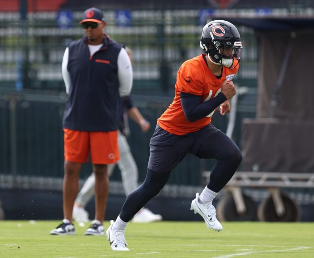 Chicago Bears GM Ryan Poles, left, watches as quarterback Caleb Williams runs during training camp at Halas Hall on July 22, 2024, in Lake Forest. (Stacey Wescott/Chicago Tribune)