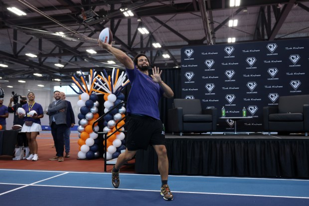 Bears quarterback Caleb Williams throws a football to a student athlete in the audience who received a Caleb Cares Hero Award through his Caleb Cares Foundation at the Dr. Conrad Worrill Track and Field Center at Gately Park on July 13, 2024, in Chicago. (John J. Kim/Chicago Tribune)