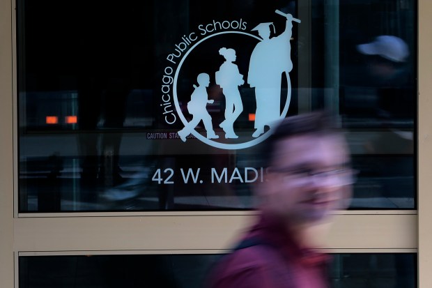 Pedestrians pass Chicago Public Schools Headquarters on Madison Street on May 28, 2024. CPS released its $9.9 billion budget on Wednesday. (Antonio Perez/Chicago Tribune)