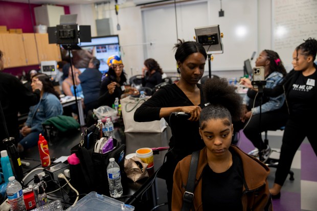 Hair stylist Janine Sylvain works on the hair of student Sadaria Douglas during an Empowerment Experience event on April 24, 2024, at Simpson Academy for Young Women in Chicago. The event was meant to empower students who are mothers or are expecting a child. (Vincent Alban/Chicago Tribune)