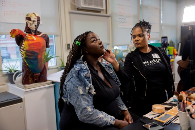 Makeup Artist Ariana Dority, right, applies makeup to student Arion Jackson during an Empowerment Experience event on April 24, 2024, at Simpson Academy for Young Women in Chicago. (Vincent Alban/Chicago Tribune)