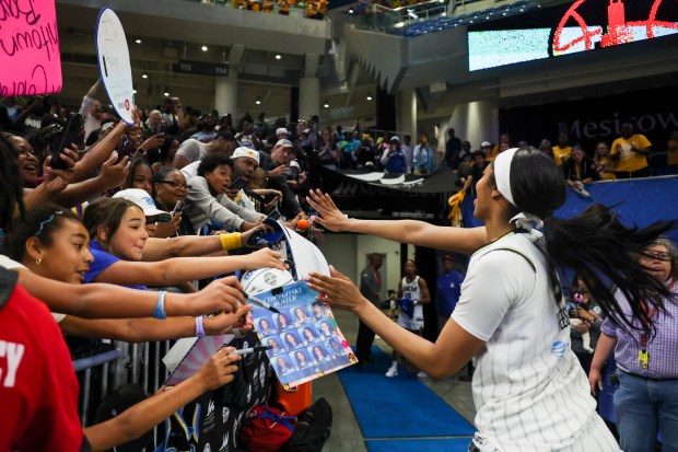 Chicago Sky forward Angel Reese (5) high-fives fans after the Chicago Sky 83-72 win over the Dallas Wings at Wintrust Arena on June 20, 2024. (Eileen T. Meslar/Chicago Tribune)