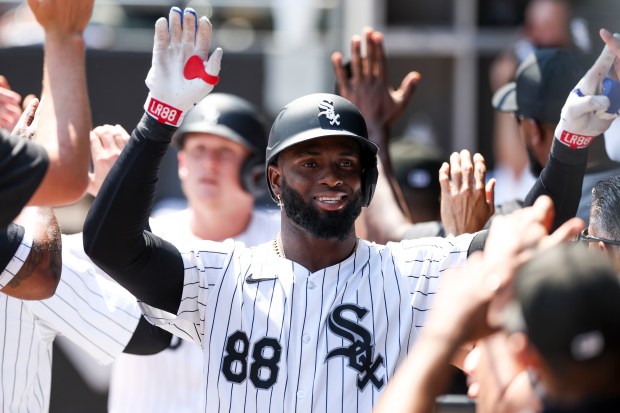 Chicago White Sox outfielder Luis Robert Jr. (88) gets high-fives from teammates after hitting a two-run home run during the sixth inning against the Minnesota Twins at Guaranteed Rate Field on July 10, 2024. (Eileen T. Meslar/Chicago Tribune)