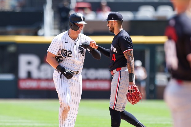 Chicago White Sox outfielder Gavin Sheets (32) gets a fist bump from Minnesota Twins shortstop Carlos Correa (4) after Sheets hit a double during the fifth inning at Guaranteed Rate Field on July 10, 2024. (Eileen T. Meslar/Chicago Tribune)