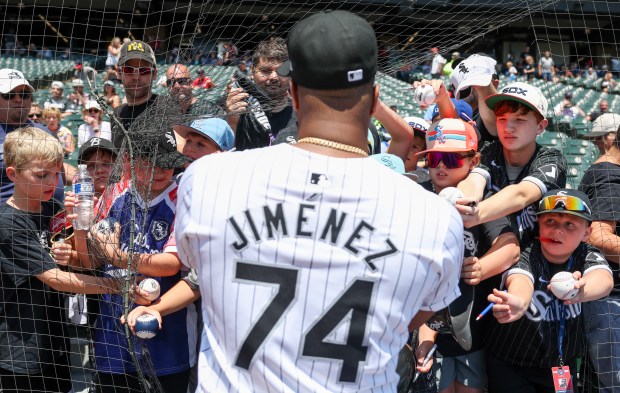 White Sox designated hitter Eloy Jiménez signs autographs for fans before Game 1 of a doubleheader against the Twins on July 10, 2024, at Guaranteed Rate Field. (Eileen T. Meslar/Chicago Tribune)