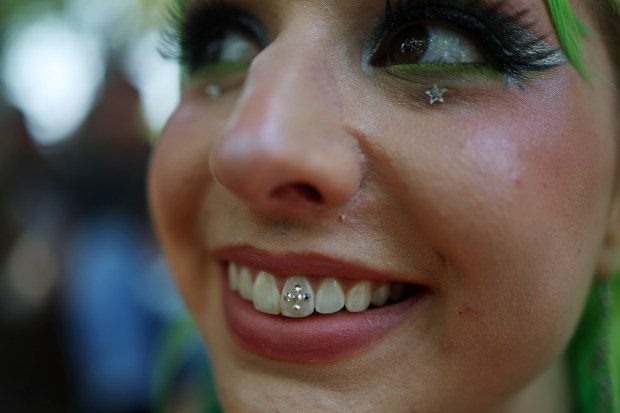 Lydia Anderson displays a tooth decoration during Pitchfork Music Festival at Union Park Friday, July 19, 2024, in Chicago. (John J. Kim/Chicago Tribune)