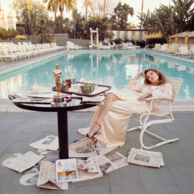 American actress Faye Dunaway sits by the pool at the Beverly Hills Hotel in Los Angeles, the morning after the Academy Awards ceremony, where she won the Oscar for 'Best Actress in a Leading Role' for her part in Sidney Lumet's satirical film "Network" on March 29, 1977. (Terry O'Neill/Iconic Images/HBO)