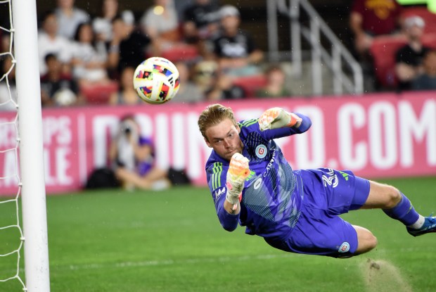 Fire goalie Chris Brady makes a diving save against D.C. United on May 25, 2024, in Washington. (John Rivera/Icon Sportswire)