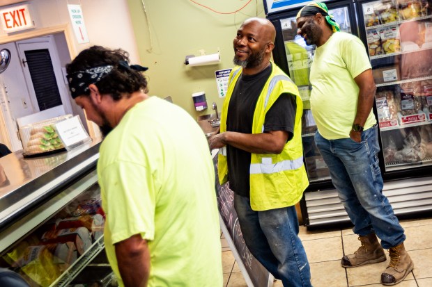 Marion Hopkins, center, orders lunch at Fontano's Subs with coworkers Luis Correa, left, and Podgiee Scott in Chicago on July 25, 2024. (Tess Crowley/Chicago Tribune)