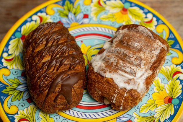 A chocolate arroz con leche croissant, left, and a arroz con leche croissant, right, on on July 13, 2024, at Pan Artesanal Bakery in Chicago. (Vincent Alban/for the Chicago Tribune)