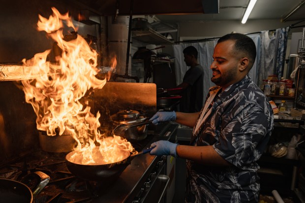 Mohmmed Mohmmed, chef at Al-Diar restaurant, cooks fahsa in Chicago on July 5, 2024. (Troy Stolt/for the Chicago Tribune)