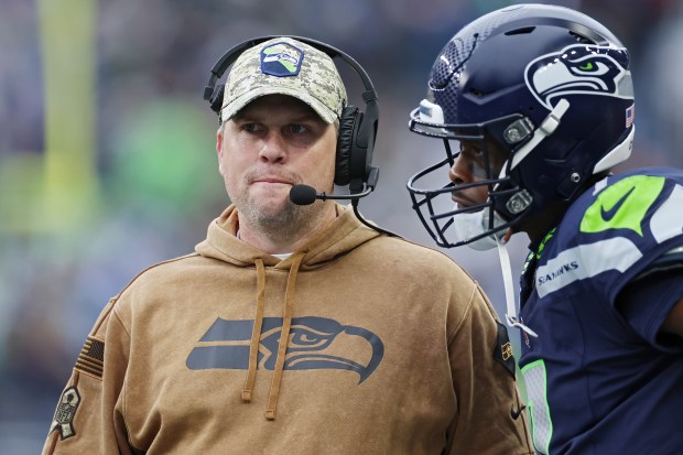 Then-Seattle Seahawks offensive coordinator Shane Waldron talks to quarterback Geno Smith during the second quarter against the Washington Commanders on Nov. 12, 2023. (Steph Chambers/Getty)