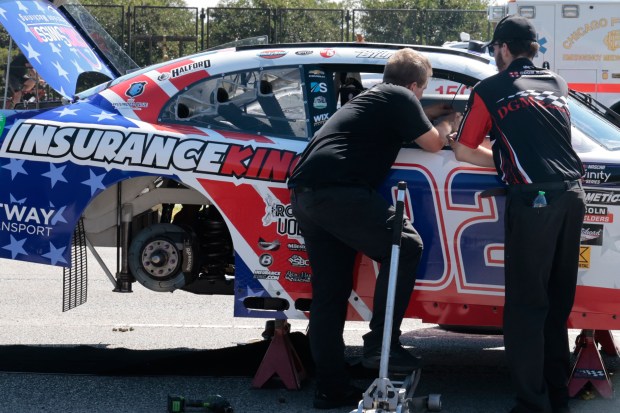 Race cars are looked over after being unloaded off trucks in preparation for the NASCAR Chicago Street Race, along DuSable Lake Shore Drive on July 5, 2024. (Antonio Perez/Chicago Tribune)