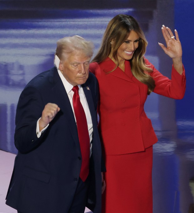 Presidential candidate Donald Trump and his wife, Melania Trump, stand together on stage after his speech during Thursday's Republican National Convention session at Fiserv Forum on July 18, 2024, in Milwaukee. (John J. Kim/Chicago Tribune)