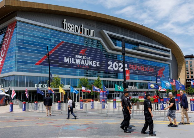 Officers and members of the press walk outside the Fiserv Forum before the first day of the Republican National Convention Sunday July 14, 2024 in Milwaukee. (Armando L. Sanchez/Chicago Tribune)