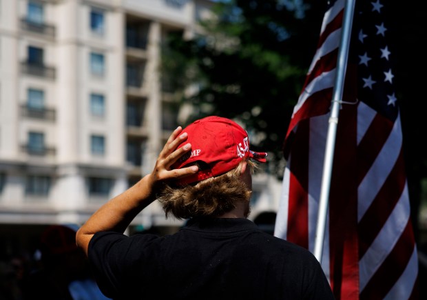 People attend a prayer vigil for former President Donald Trump the day after Trump survived an attempted assassination during a rally in Pennsylvania Sunday July 14, 2024 in Milwaukee. The vigil was held in Zeidler Union Square park before the first day of the Republican National Convention. (Armando L. Sanchez/Chicago Tribune)