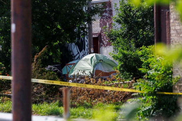 Officers investigate the scene where police from Columbus, Ohio, fatally shot a man near the intersection of North 14th Street and West Vliet Street on July 16, 2024, in Milwaukee. (Armando L. Sanchez/Chicago Tribune)