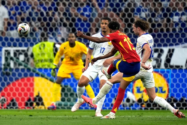 Lamine Yamal, center, scores Spain's first goal during a semifinal against France at the Euro 2024 tournament in Munich on Tuesday, July 9. (AP Photo/Matthias Schrader)