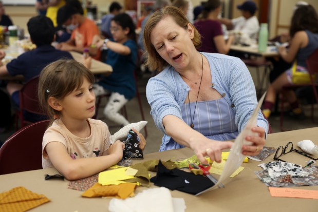 Kara Murray, right, helps her niece Josephine Murray, 7, make a fabric bird during a bird-making workshop for Bird Collisions in the Anthropocene at the Evanston Public Library on July 15, 2024. (Eileen T. Meslar/Chicago Tribune)