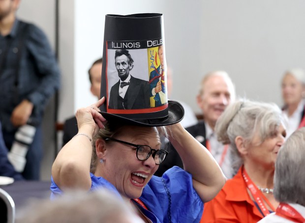 Robin Hans has fun while sporting a Abraham Lincoln-inspired top hat at the Illinois Republican Party Delegation Breakfast in Oak Creek, Wisconsin, on July 17, 2024. (Stacey Wescott/Chicago Tribune)