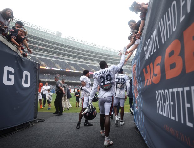 Chicago Bears cornerback Josh Blackwell (39) high-fives fans while walking out for Chicago Bears Family Fest at Soldier Field on Sunday, Aug. 6, 2023. (Trent Sprague/Chicago Tribune)