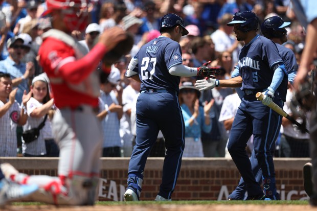 Cubs right fielder Seiya Suzuki (27) is congratulated by teammate Christopher Morel after Suzuki hit a two-run home run in the first inning on July 5, 2024, at Wrigley Field. (Chris Sweda/Chicago Tribune)