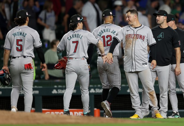 Arizona Diamondbacks outfielders Alek Thomas (5) and Corbin Carroll (7) celebrate with Joc Pederson (fourth from left) after a victory over the Chicago Cubs at Wrigley Field in Chicago on July 20, 2024. (Chris Sweda/Chicago Tribune)