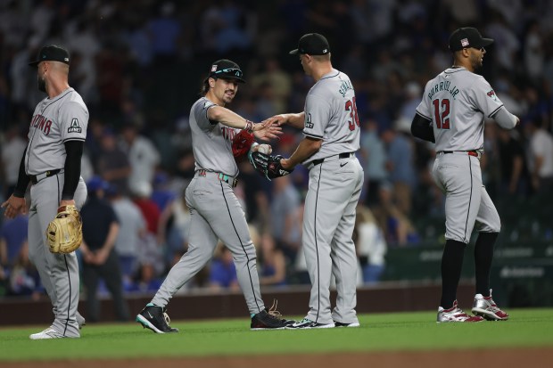 Arizona Diamondbacks outfielder Corbin Carroll (left) and pitcher Paul Sewald (center) celebrate after a victory over the Chicago Cubs at Wrigley Field in Chicago on July 20, 2024. (Chris Sweda/Chicago Tribune)