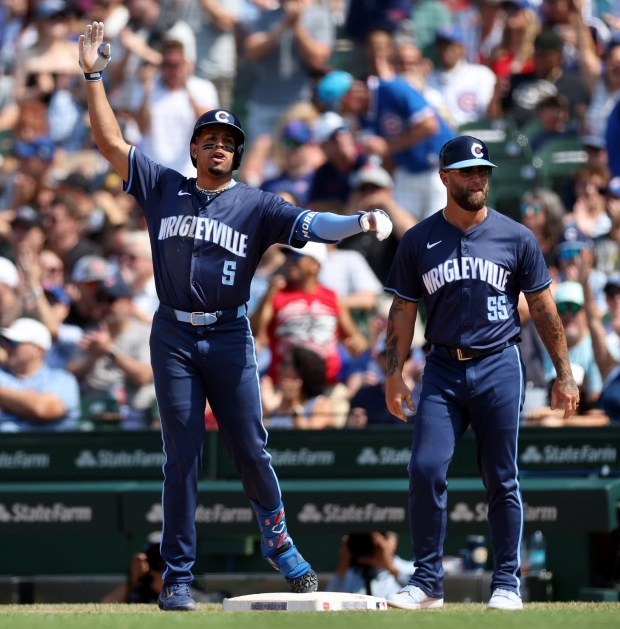 Cubs designated hitter Christopher Morel (5) celebrates at first base after driving in a run with a single in the sixth inning on July 19, 2024, at Wrigley Field. (Chris Sweda/Chicago Tribune)