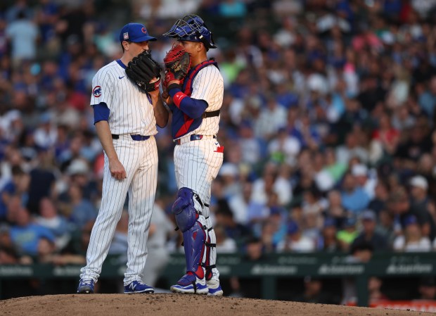 Chicago Cubs starting pitcher Kyle Hendricks and catcher Miguel Amaya meet on the mound in the fifth inning of a game against the Arizona Diamondbacks at Wrigley Field in Chicago on July 20, 2024. (Chris Sweda/Chicago Tribune)