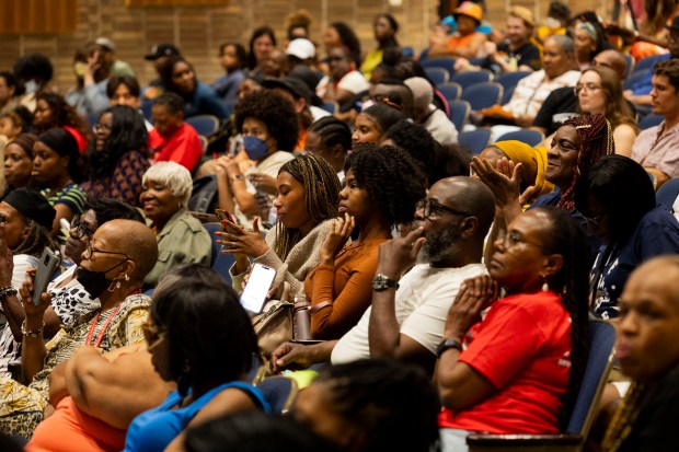 Community members sit in the audience during a Community Benefits Agreement (CBA) Coalition meeting held to discuss rising rents and property taxes on June 22, 2024, at Hyde Park Academy High School in Chicago. (Vincent Alban/Chicago Tribune)