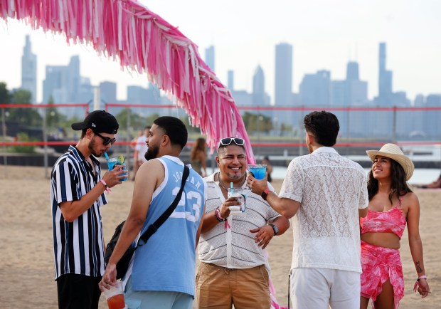 With the Chicago skyline in the background, people relax at Miche Fest at Oakwood Beach in Chicago on July 13, 2024. (Chris Sweda/Chicago Tribune)