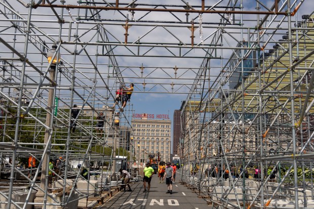 Workers construct a three-story grandstand which includes the Skyline premium hospitality club overlooking pit road and the start/finish line at Buckingham Fountain for the NASCAR Chicago Street Race on June 13, 2024, on Ida B. Wells Drive in Grant Park. (Brian Cassella/Chicago Tribune)