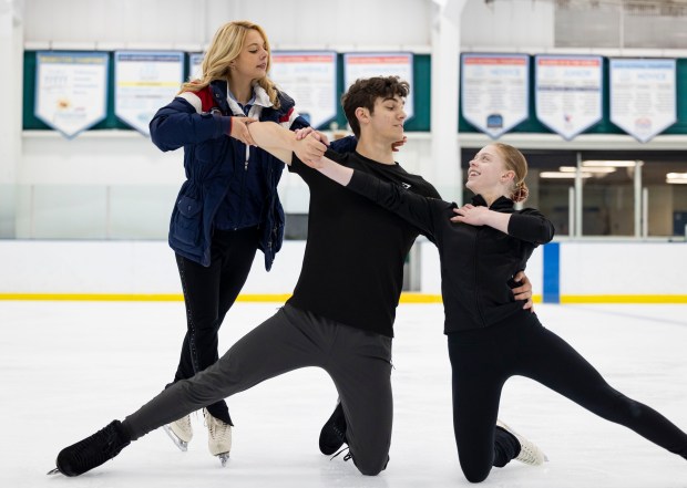 Former Olympic figure skater Alexa Knierim, left, works with Aaron Felberbaum and Addyson McDanold on the rink at the Northbrook Sports Center, where she now teaches. (Brian Cassella/Chicago Tribune)