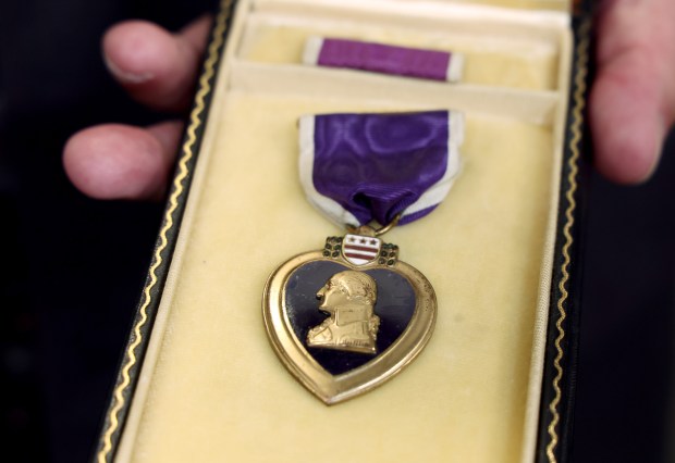 Jim Even holds the Purple Heart belonging to his father, WWII veteran Jerome Even on July 1, 2024. The medal was returned to Even's family by the Illinois State Treasurer's office after it was discovered in a safety security box. (Stacey Wescott/Chicago Tribune)