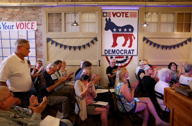 People applaud as Peter Barca, left, running for a seat in Wisconsin's 1st Congressional District, is introduced during a Democratic Party of Racine County monthly membership meeting in Racine, Wisconsin, on July 18, 2024. (Chris Sweda/Chicago Tribune)