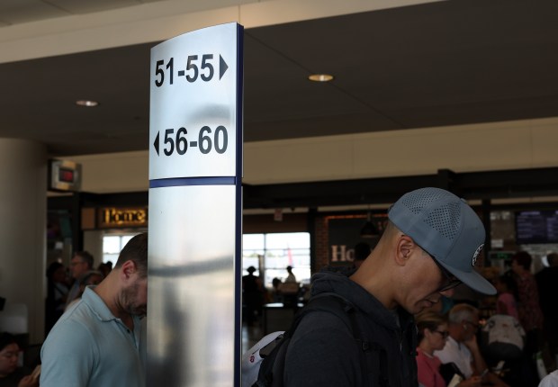 Southwest Airlines passengers stand next to boarding group posts for a flight at Midway International Airport on July 25, 2024. (John J. Kim/Chicago Tribune)