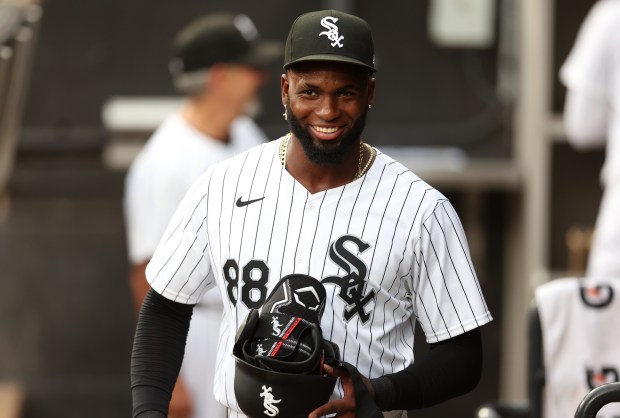White Sox center fielder Luis Robert Jr. flashes a smile in the dugout before a game against the Dodgers on June 25, 2024, at Guaranteed Rate Field. (Chris Sweda/Chicago Tribune)