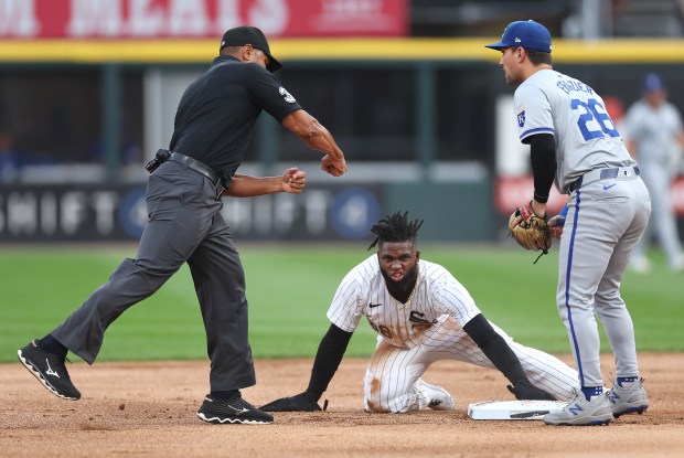 Second base umpire Jeremy Rehak calls out Chicago White Sox center fielder Luis Robert Jr. after Robert Jr. was tagged out by Kansas City Royals second baseman Adam Frazier (right) on a steal attempt in the first inning of a game at Guaranteed Rate Field in Chicago on July 30, 2024. (Chris Sweda/Chicago Tribune)