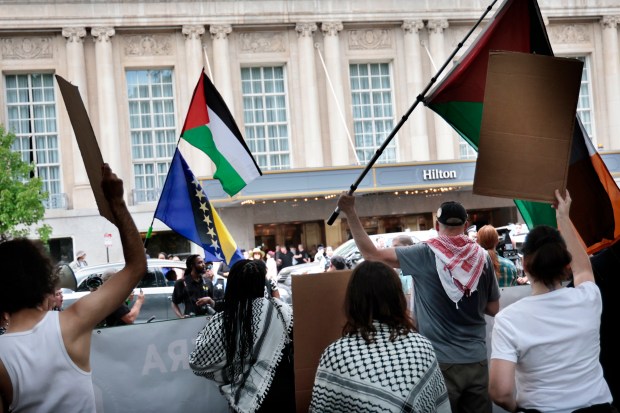 Dozens of protesters rally at Grant Park as former president Donald Trump participates in a conversation with journalists at the National Association of Black Journalists convention on July 31, 2024, at the Hilton Chicago.   (Antonio Perez/Chicago Tribune)