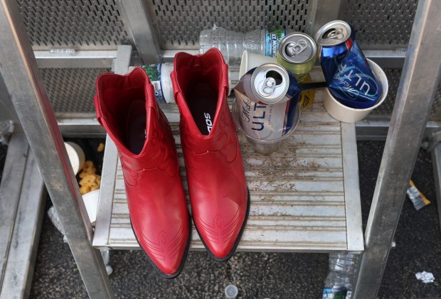 A pair of red boots are seen sitting next to garbage at the annual Windy City Smokeout outside of the United Center in Chicago on Friday, July 12, 2024. (Chris Sweda/Chicago Tribune)