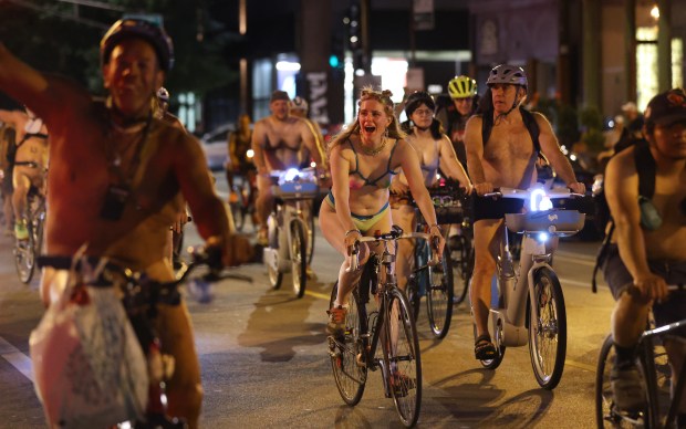 People participate in the World Naked Bike Ride through Chicago on June 29, 2024. (Chris Sweda/Chicago Tribune)