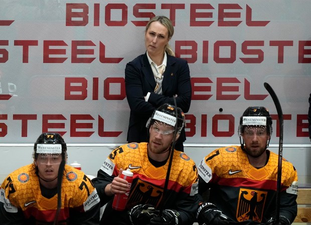 Germany assistant coach Jessica Campbell stands behind players during a World Championship match in Helsinki, Finland, on May 16, 2022. (AP Photo/Martin Meissner, File)