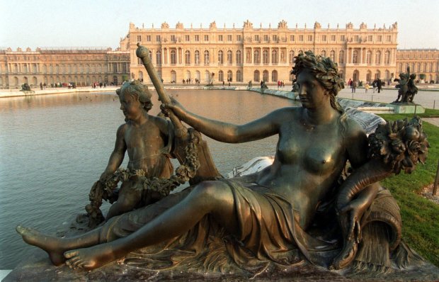 The statue "Nymphe et enfant au trident" by Philippe Magnier is seen in the gardens of the Chateau de Versailles, outside Paris on Sept.19, 2023. During the Summer Olympics, equestrian riders will gallop at the heart of the palace's gardens and modern pentathlon events also take place there. (Christophe Ena/AP)