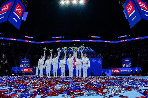 Hezly Rivera, Joscelyn Roberson, Suni Lee, Simone Biles, Jade Carey, Jordan Chiles and Leanne Wong smile after they were named to the Olympic team at the United States Gymnastics Olympic Trials on June 30, 2024, in Minneapolis. (AP Photo/Charlie Riedel)