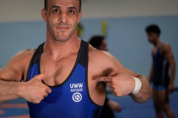 Iranian wrestler Iman Mahdavi, 28, poses at the Lotta Club Seggiano gym, in Pioltello, northern Italy, on Feb. 28, 2024. (AP Photo/Luca Bruno)