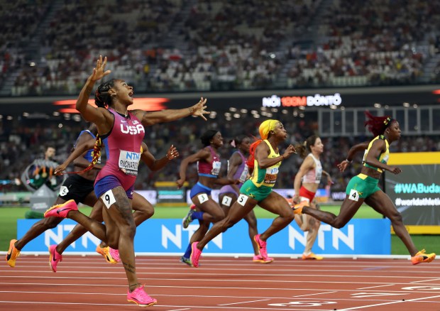 Sha'Carri Richardson crosses the finish line to win the 100-meter final during the World Athletics Championships at National Athletics Centre on Aug. 21, 2023, in Budapest, Hungary. (Michael Steele/Getty Images/TNS)