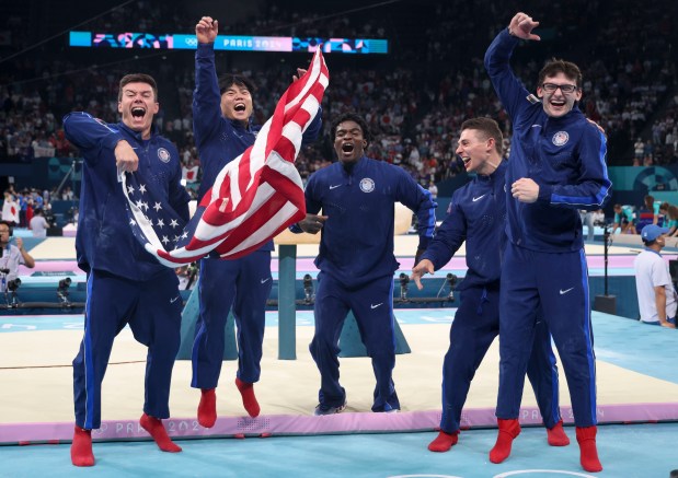 Members of the U.S. gymnastics team, Brody Malone, Asher Hong, Frederick Richard, Paul Juda and Stephen Nedoroscik celebrate winning the bronze medal in the men's team final Monday, July 29, 2024, at Bercy Arena during the Paris Olympics. (Brian Cassella/Chicago Tribune)