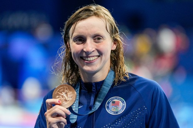 Bronze medalist Katie Ledecky, of the United States, poses after the women's 400-meter freestyle final at the 2024 Summer Olympics, Saturday, July 27, 2024, in Nanterre, France. (AP Photo/Ashley Landis)