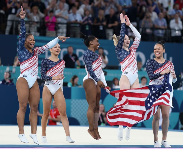 Jordan Chiles, Hezly Rivera, Simone Biles Jade Carey and Suni Lee celebrate as the U.S. wins gold in the women's gymnastics team final Tuesday, July 30, 2024, at Bercy Arena during the Paris Olympics. (Brian Cassella/Chicago Tribune)